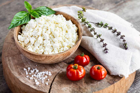 Riccota goat cheese on rustic wooden background. Dairy product of private farm. Homemade cheese. Healthy food, dieting.の写真素材