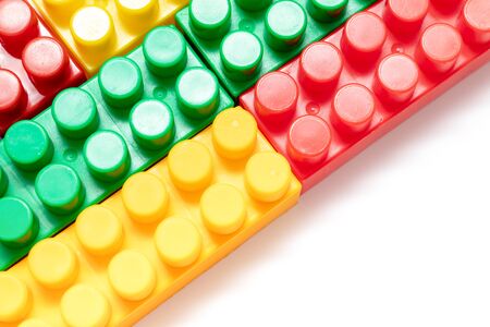 Many colorful toy plastic bricks, kit of blocks for building and constructing on white background with copy space.の写真素材