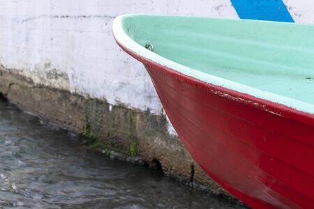 A red fishing boat on a sea shore with copy space.