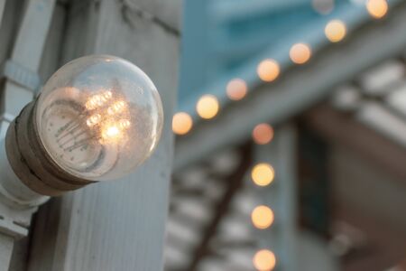 Outdoor backyard patio led lighting on wooden beam with copy space, party decorations background.の写真素材