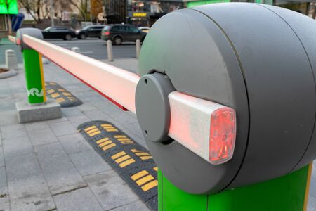 Road barrier gate for cars to get access to the parking lot close up.
