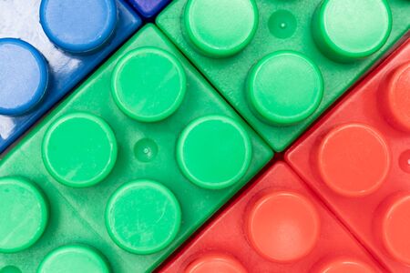 Colorful background made of toy plastic bricks, blocks for constructing and building by children.