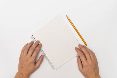 Woman hands holding a notebook and a yellow pencil ready to write, close up top view copy space.の写真素材