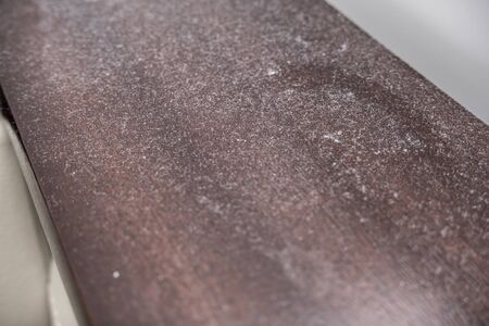 A lot of dust on wooden polished surface of furniture, dusty home concept.の写真素材