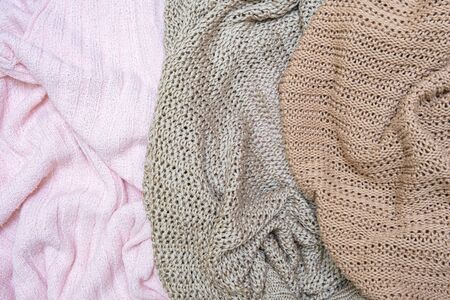 Knitwear background of different colors - pink, beige and brown, washing and laundry of delicate...