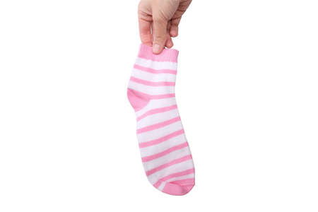 A hand holding one pink and white striped cotton organic sock isolated on white.の写真素材