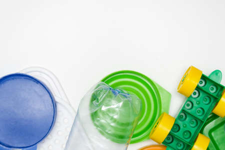 Many pet plastic objects, things bottles toys caps that can be recycled in order to save nature and protect environment on white background with copy spaceの写真素材