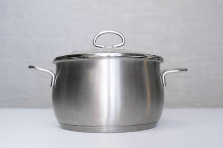 Stainless steel pot, stockpot on white table, eco friendly kitchen utensils without harm, harmless safe for peopleの写真素材