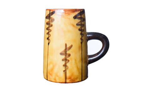 A big yellow old fashioned ceramic beer mug isolated on white, glazed clay dishwareの写真素材
