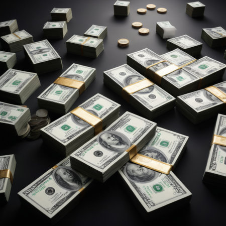 Piles of US dollar bills with coins on black backgroundの素材