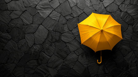 Isolated yellow umbrella on dark stone pavementの素材