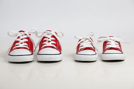 Red Shoes isolated on white. Big Brother - Conceptの写真素材