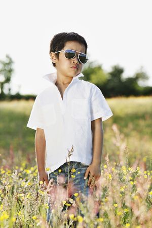 Outdoor spring/summer portrait in a middle of wild meadow.の写真素材