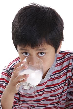 A young boy drinking a glass of milkの写真素材