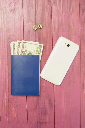 International passport and money for travel on a pink backgroundの写真素材