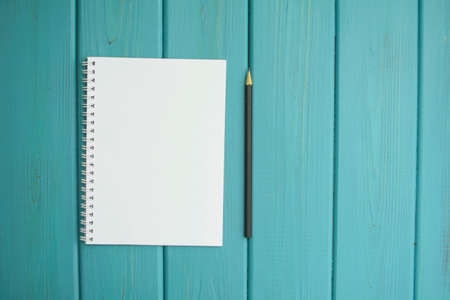 Blank notebook for notes with pencil on pink backgroundの写真素材