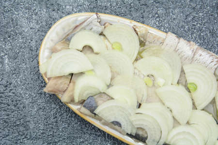 Delicious fresh peeled herring in marinade