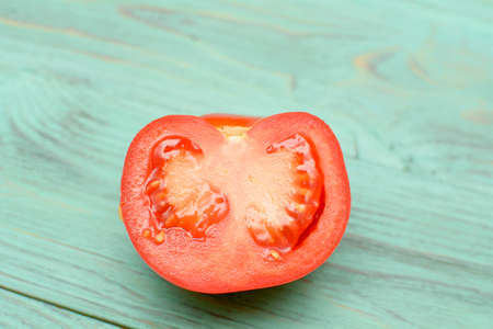 Beautiful juicy red tomato on a light backgroundの写真素材