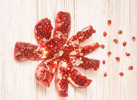 Beautiful juicy pomegranate in a cut on a light backgroundの写真素材