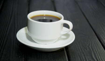 Delicious custard coffee in cups on the background of coffee beansの写真素材