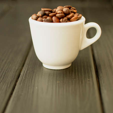 Delicious custard coffee in cups on the background of coffee beans