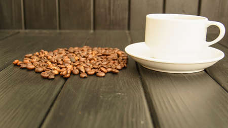 Delicious custard coffee in cups on the background of coffee beans