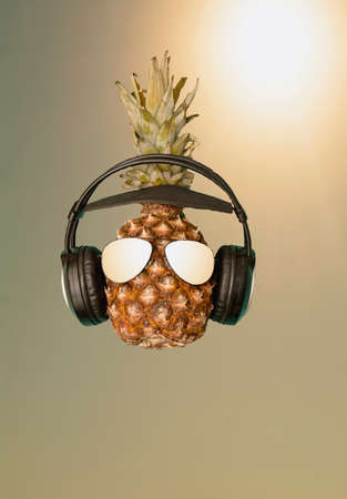 Ripe delicious juicy pineapple listens to musicの写真素材