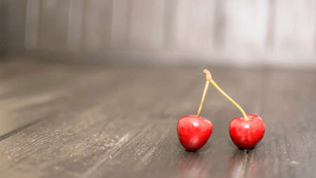 Many ripe cherries on a beautiful background in a plateの写真素材