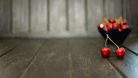 Many ripe cherries on a beautiful background in a plateの写真素材