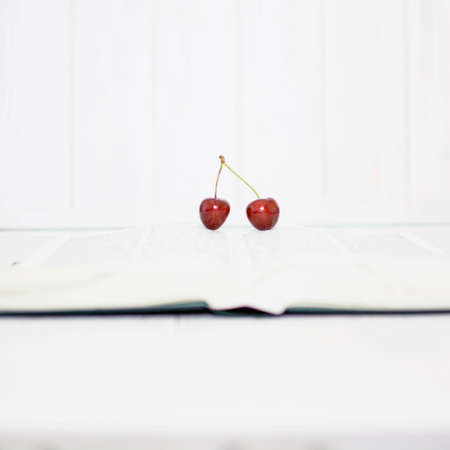 Many ripe cherries on a beautiful background in a plateの写真素材