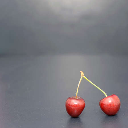 Many ripe cherries on a beautiful background in a plateの写真素材