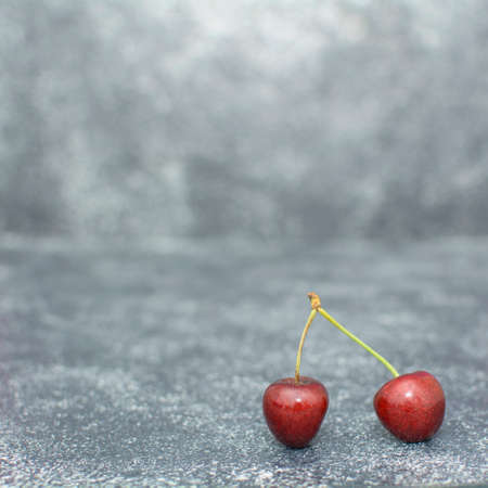 Many ripe cherries on a beautiful background in a plateの写真素材