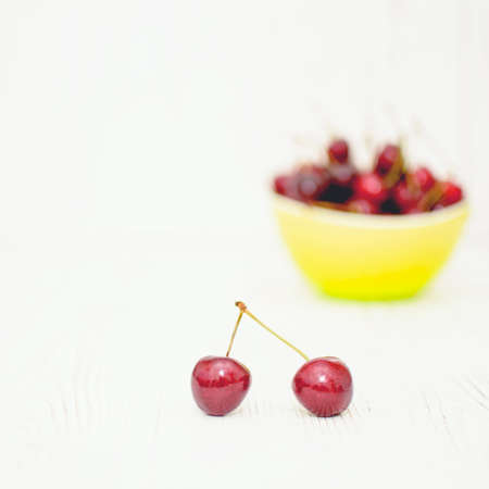 Many ripe cherries on a beautiful background in a plate