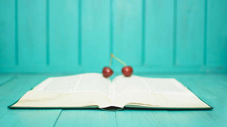 Many ripe cherries on a beautiful background in a plateの写真素材