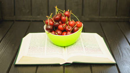 Many ripe cherries on a beautiful background in a plate