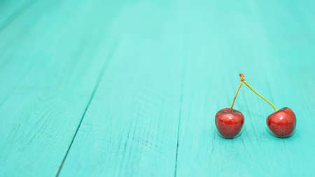 Many ripe cherries on a beautiful background in a plateの写真素材