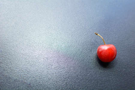 Many ripe cherries on a beautiful background in a plateの写真素材