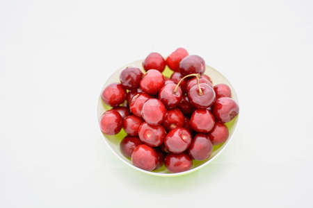 Many ripe cherries on a beautiful background in a plate