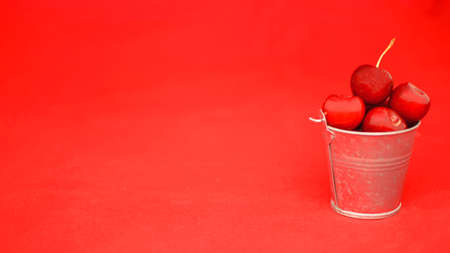 Many ripe cherries on a beautiful background in a plateの写真素材