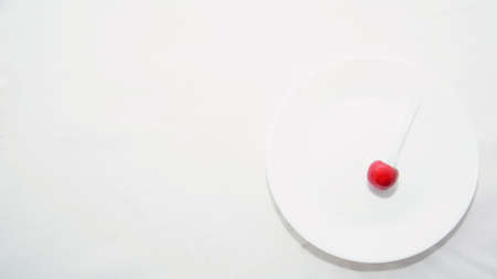 Many ripe cherries on a beautiful background in a plateの写真素材
