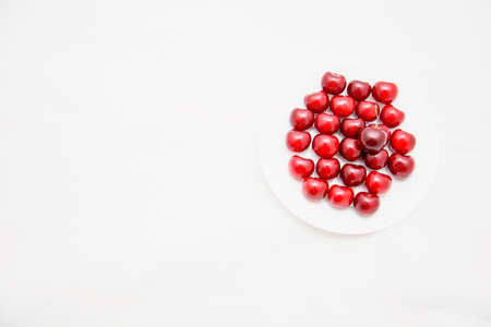 Many ripe cherries on a beautiful background in a plate