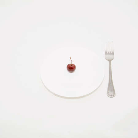 Many ripe cherries on a beautiful background in a plateの写真素材