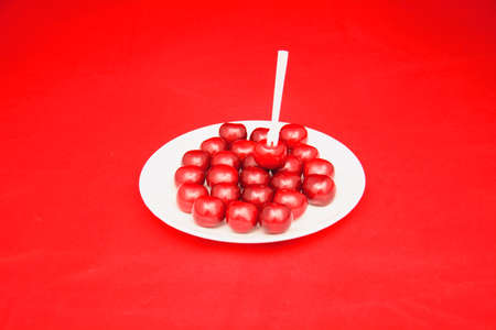 Many ripe cherries on a beautiful background in a plateの写真素材