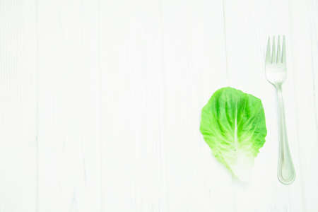 Green fresh lettuce leaves on light backgroundの写真素材