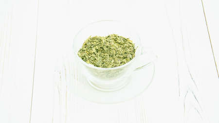 Green tea in a transparent cup on a light backgroundの写真素材