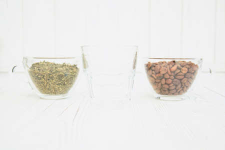 Cup of coffee and a cup of tea close up on a light backgroundの写真素材