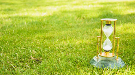 Beautiful hourglass stand against the background of beautiful natureの写真素材
