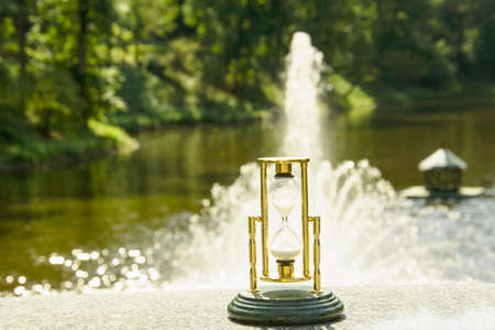 Beautiful hourglass stand against the background of beautiful natureの写真素材