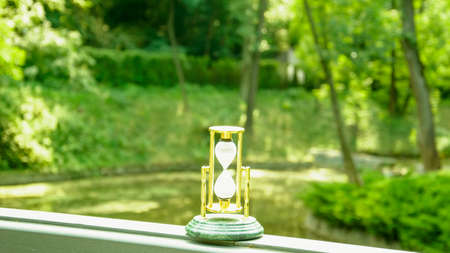Beautiful hourglass stand against the background of beautiful natureの写真素材