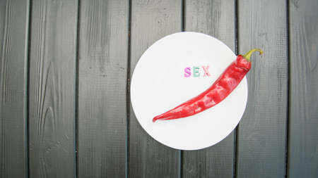 Red hot chilly juicy pepper on a dark background